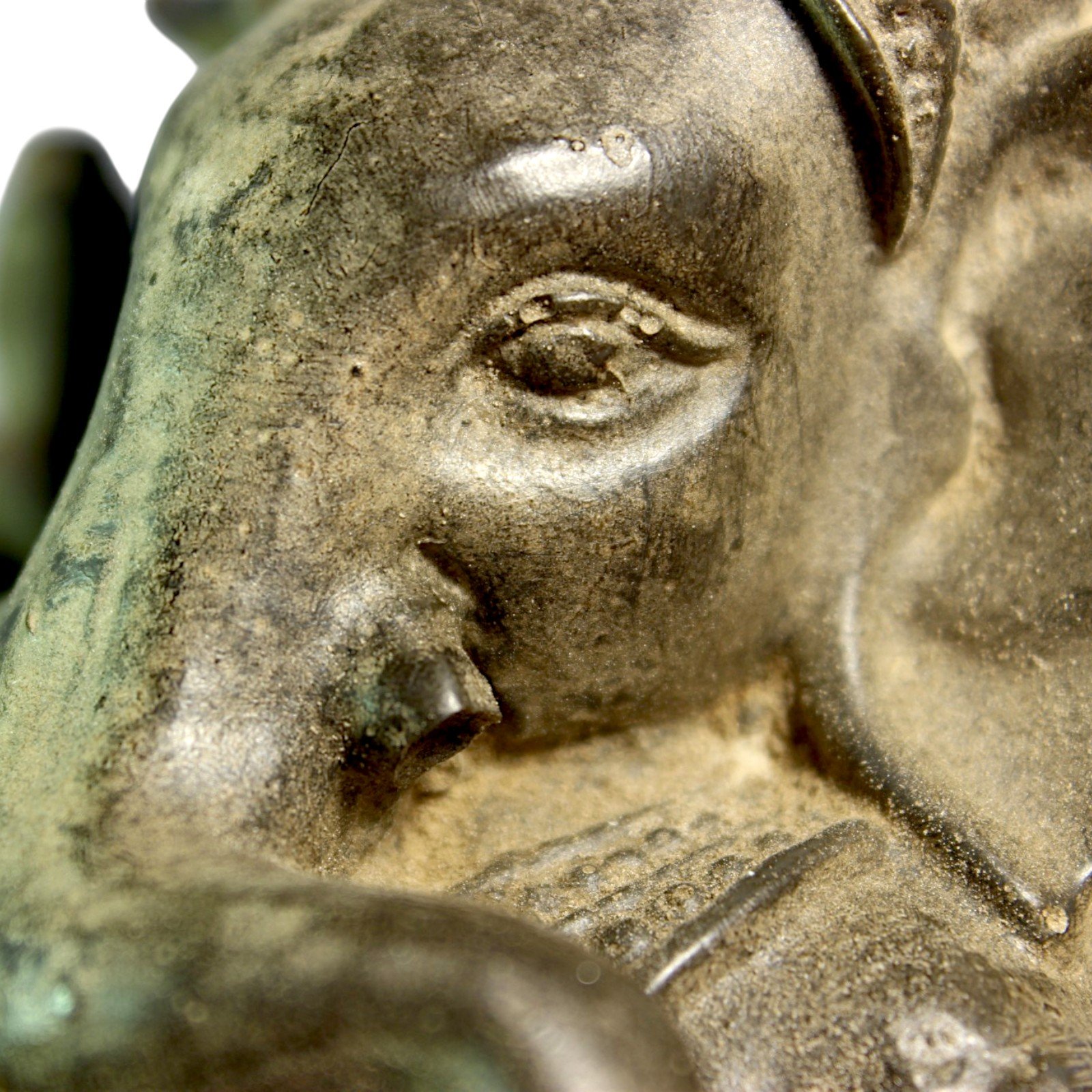 Macro shot of the statue's eye showing hand-applied antiquing detail