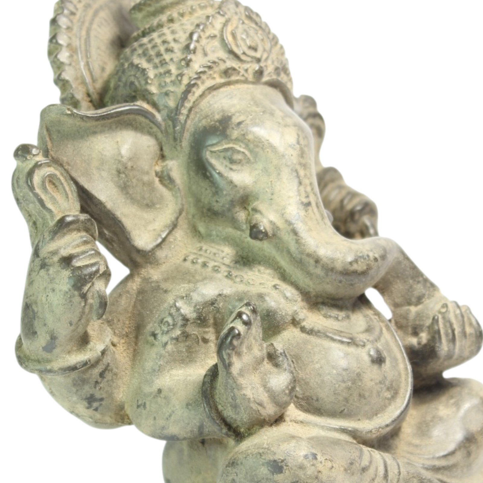 Close-up of Ganesha's face, trunk, and hand detail showing hand-painted patina
