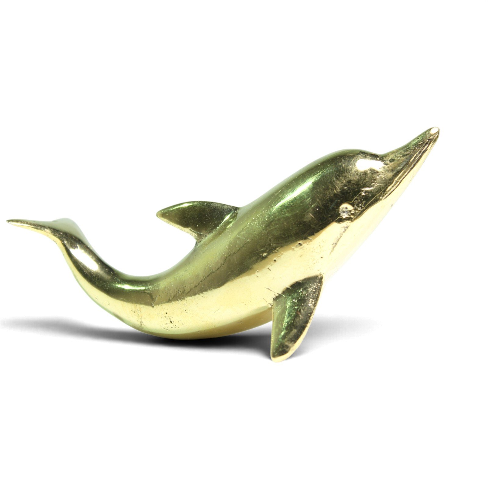 Side view of the brass dolphin figurine showing full curved silhouette