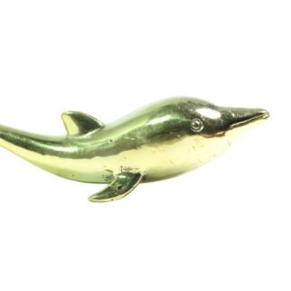 Brass dolphin figurine viewed from the side showing curved body and dorsal fin