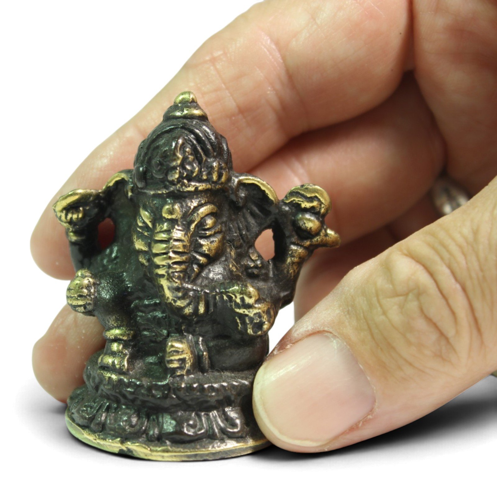 Hand holding the brass Ganesha bust to show its small scale