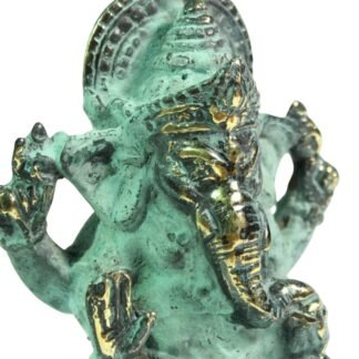 Close-up of the Ganesha figurine's crowned head and raised hands in verdigris brass