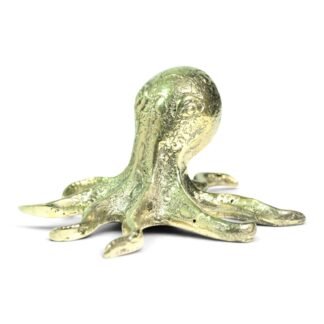 Large hand-cast brass octopus figurine viewed from the front, showing textured head and curled legs