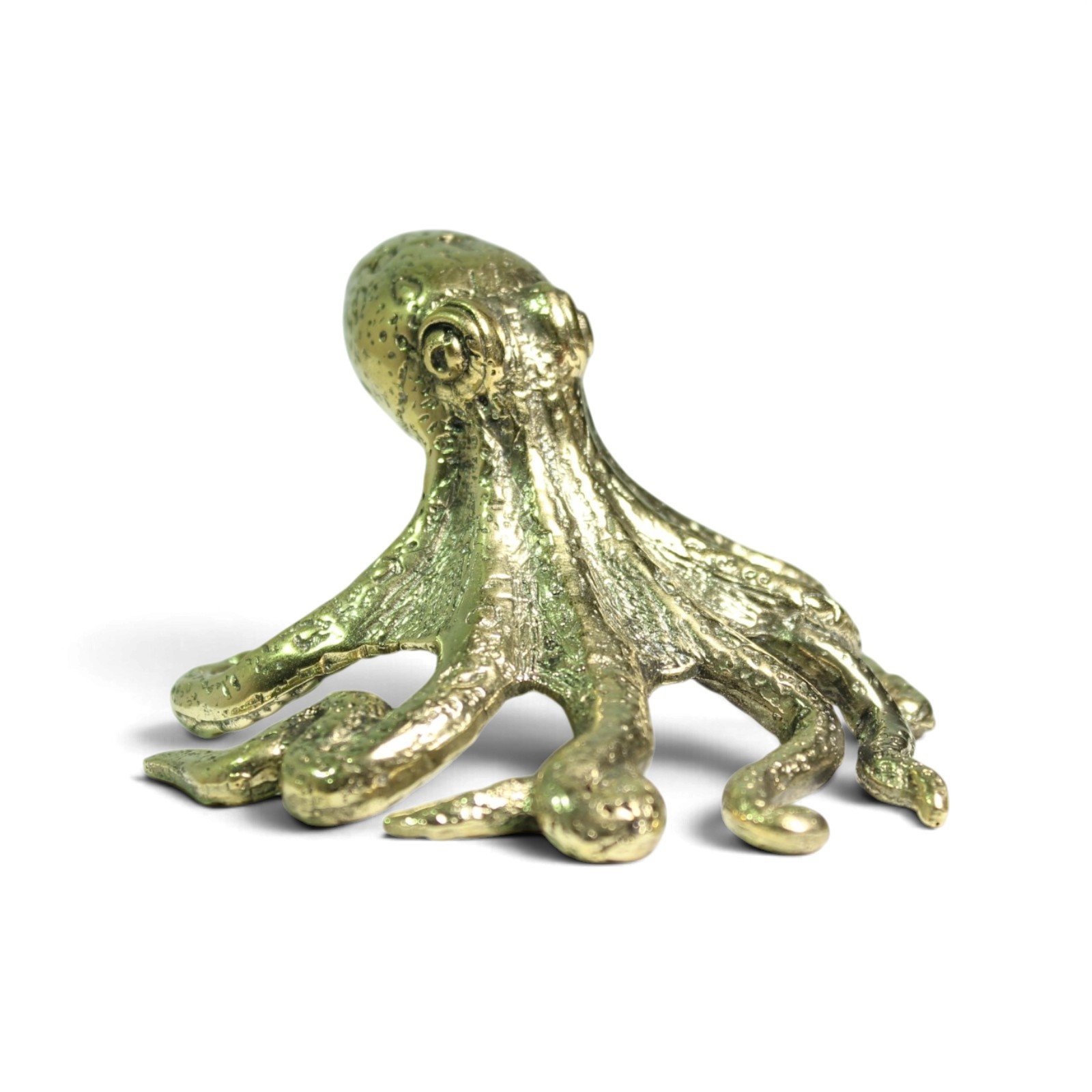 Hand-cast brass octopus figurine, small head, side angle showing textured tentacles