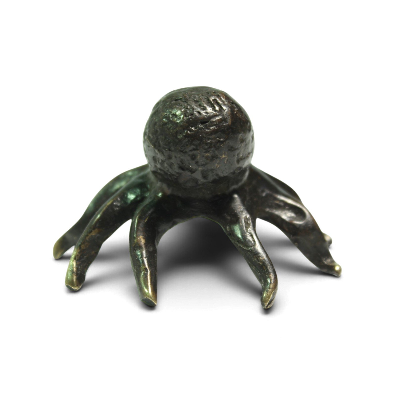 Brass octopus figurine seen head-on with legs spread toward camera