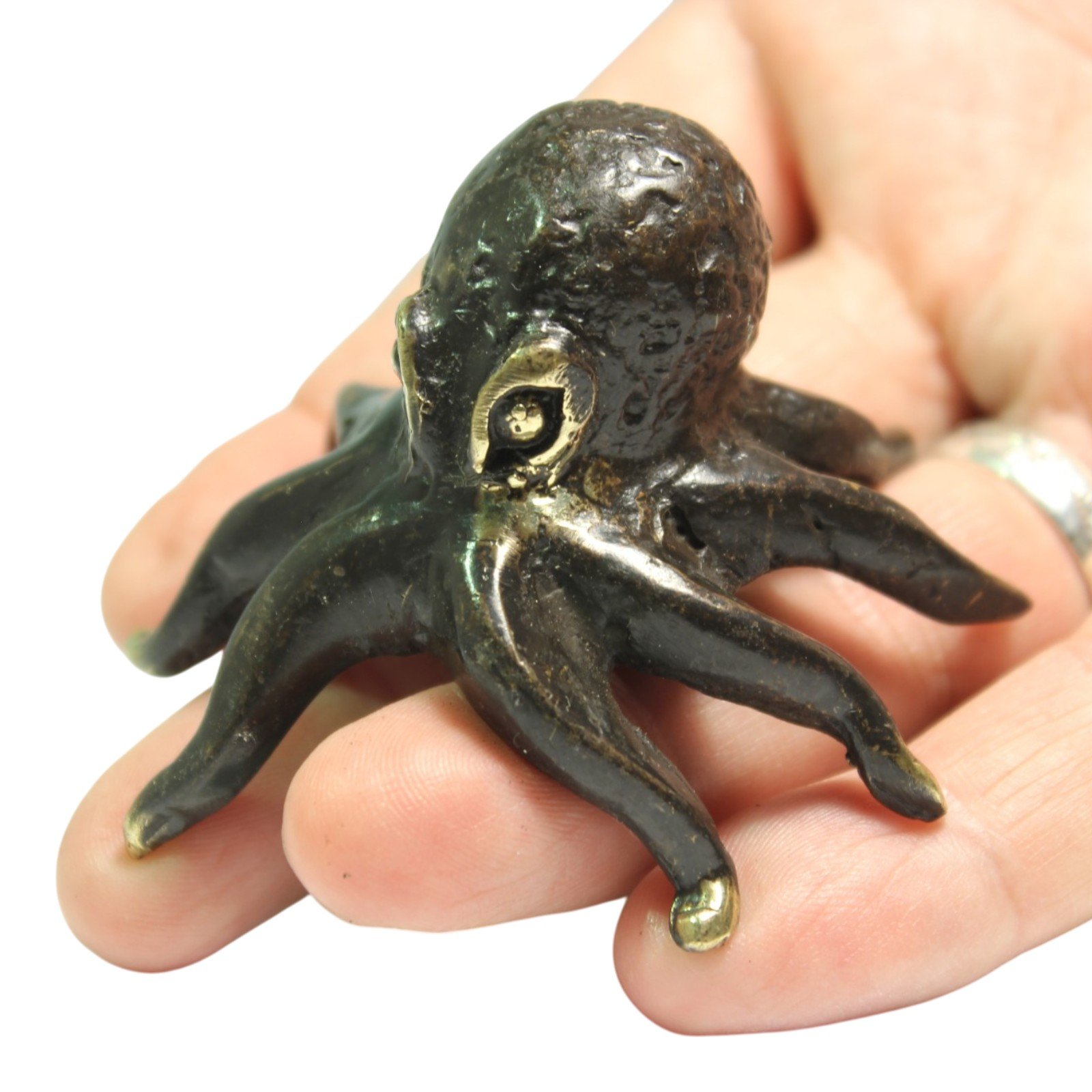 Octopus figurine held in hand showing its small scale
