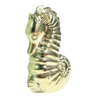 Close-up side view of brass seahorse figurine head and coiled tail with gold finish
