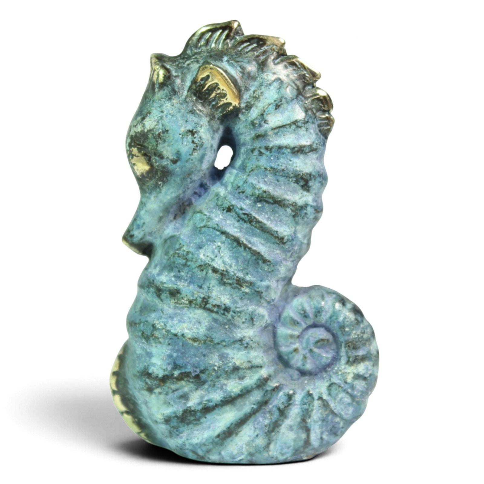 Side profile of brass seahorse figurine showing curled tail and ridged body texture