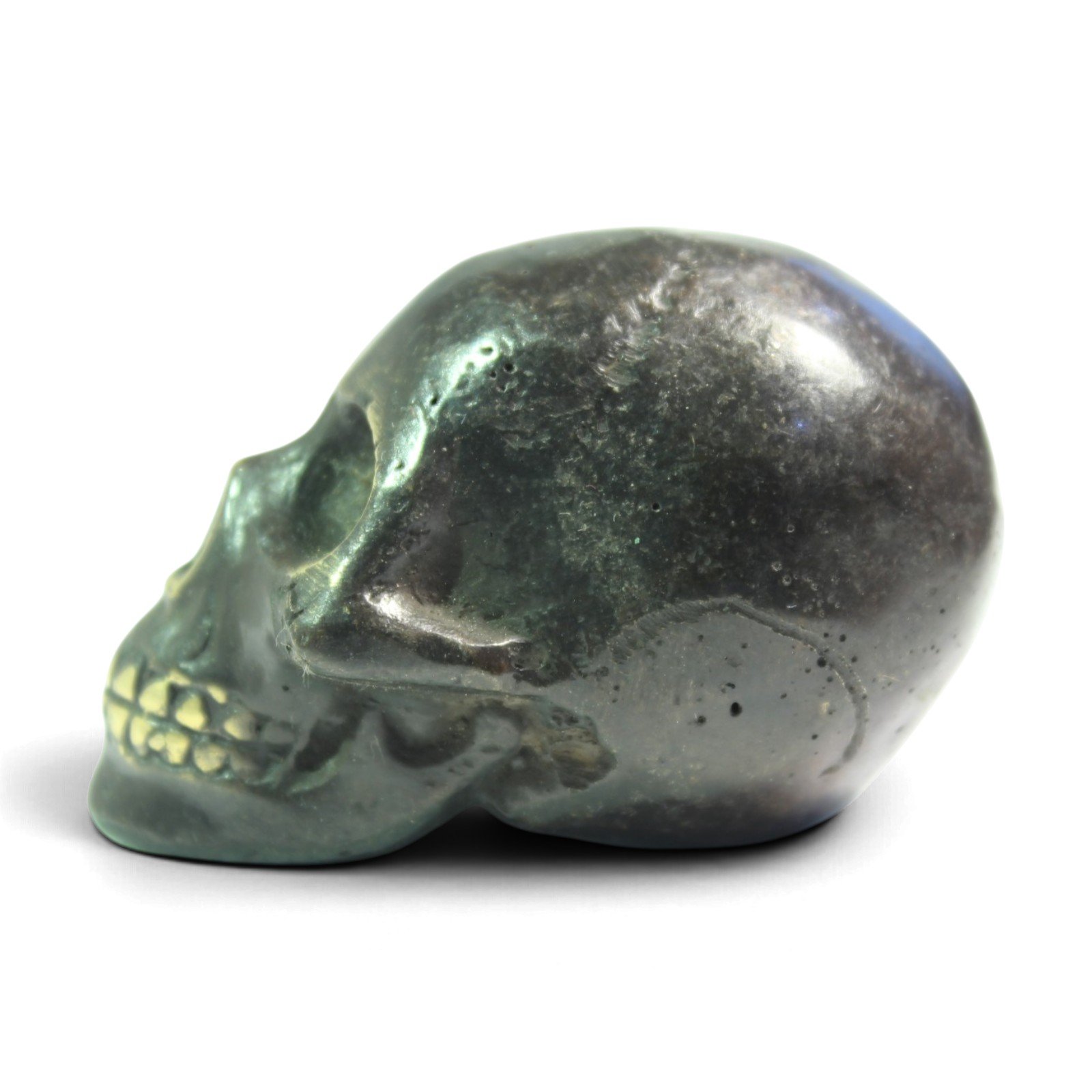 Three-quarter side view of the brass skull showing rounded cranium and jaw