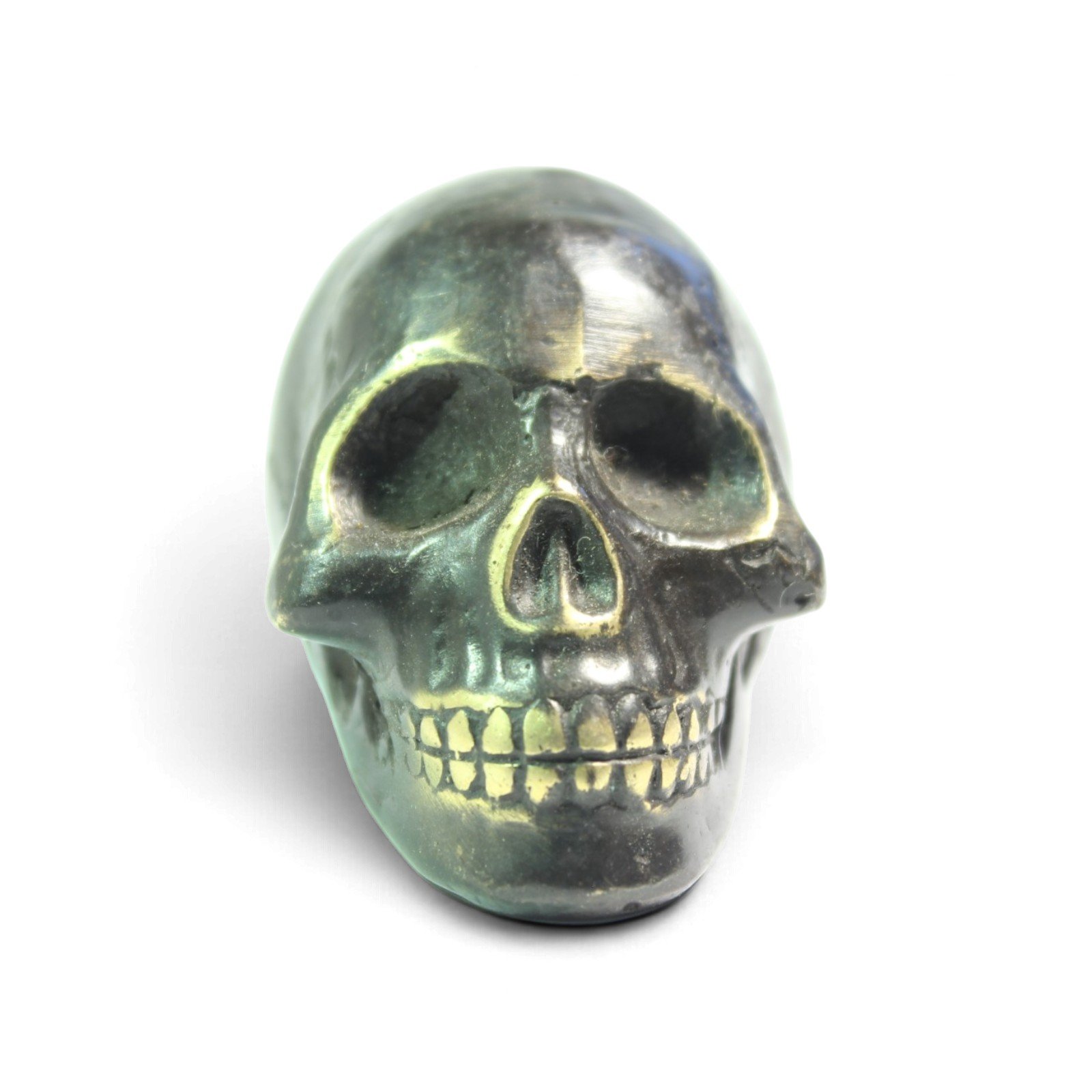 Front-facing view of the brass skull figurine showing eye sockets and teeth