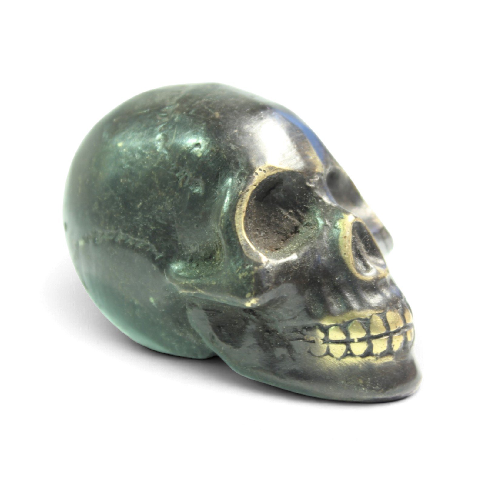 Side view of black-oxidized brass skull figurine showing profile and jaw detail