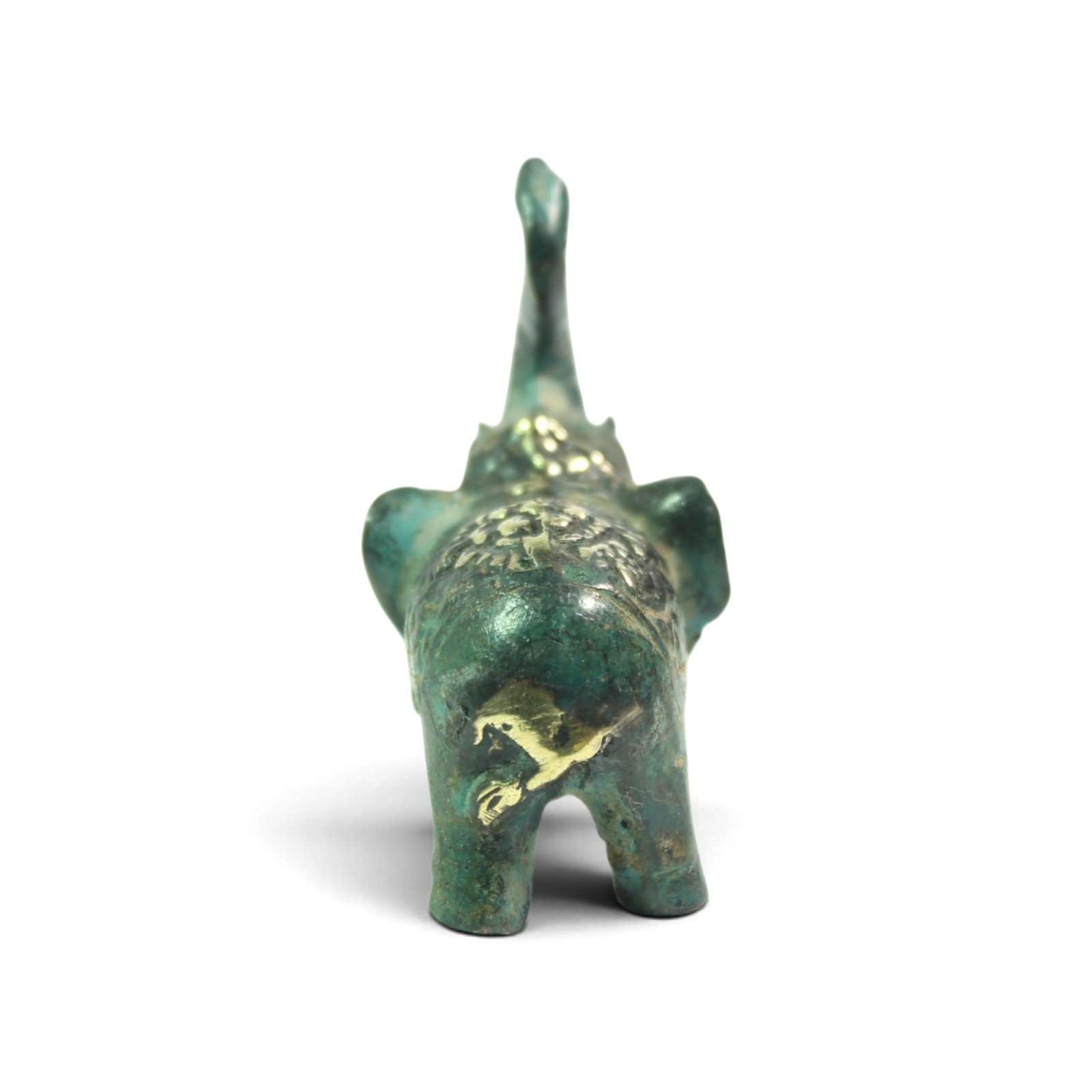 Rear view of brass elephant figurine showing tail, ears, and small horse motif on hindquarters