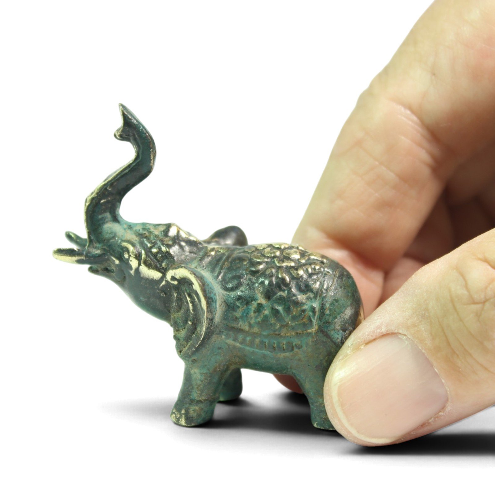 Side view of brass elephant figurine showing textured back