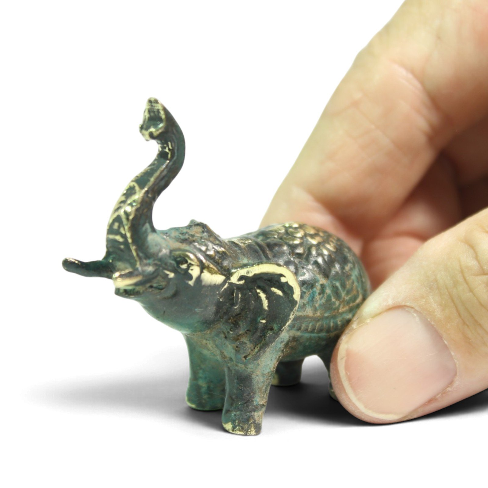 Side view of brass elephant figurine showing textured back