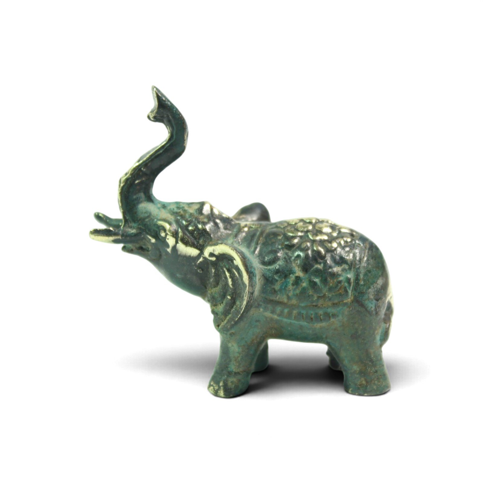 Side view of brass elephant figurine showing textured back blanket and tusk detail
