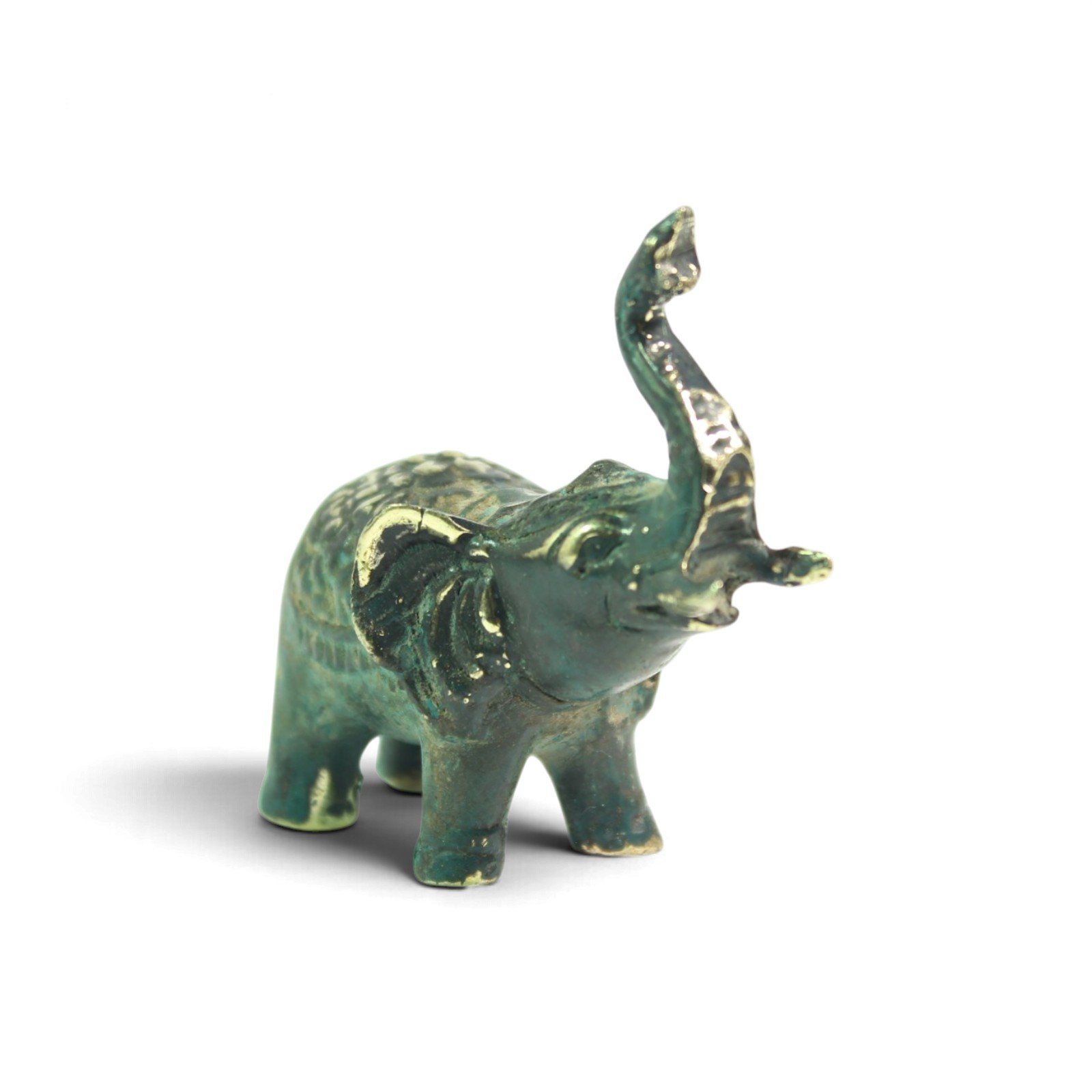 Side view of brass elephant figurine showing textured back