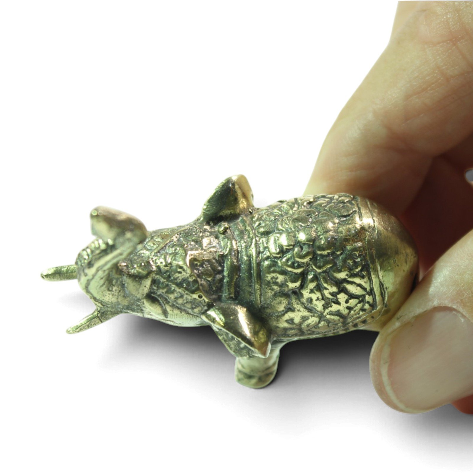 Overhead view of brass elephant figurine showing patterned back and raised trunk