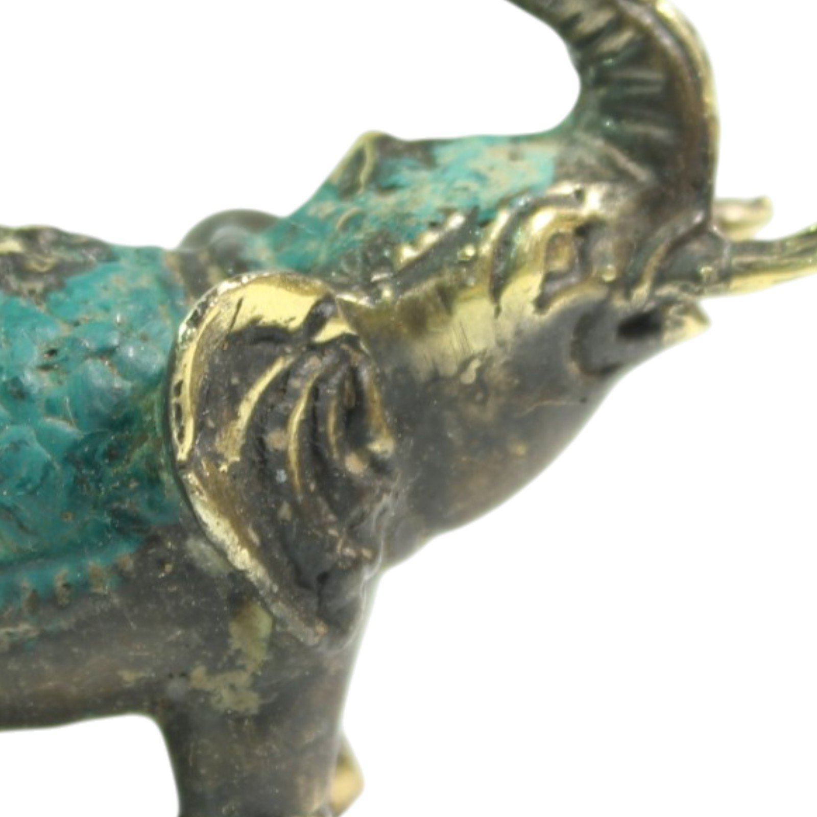 Close-up of the elephant's ear and trunk showing teal patina and casting detail