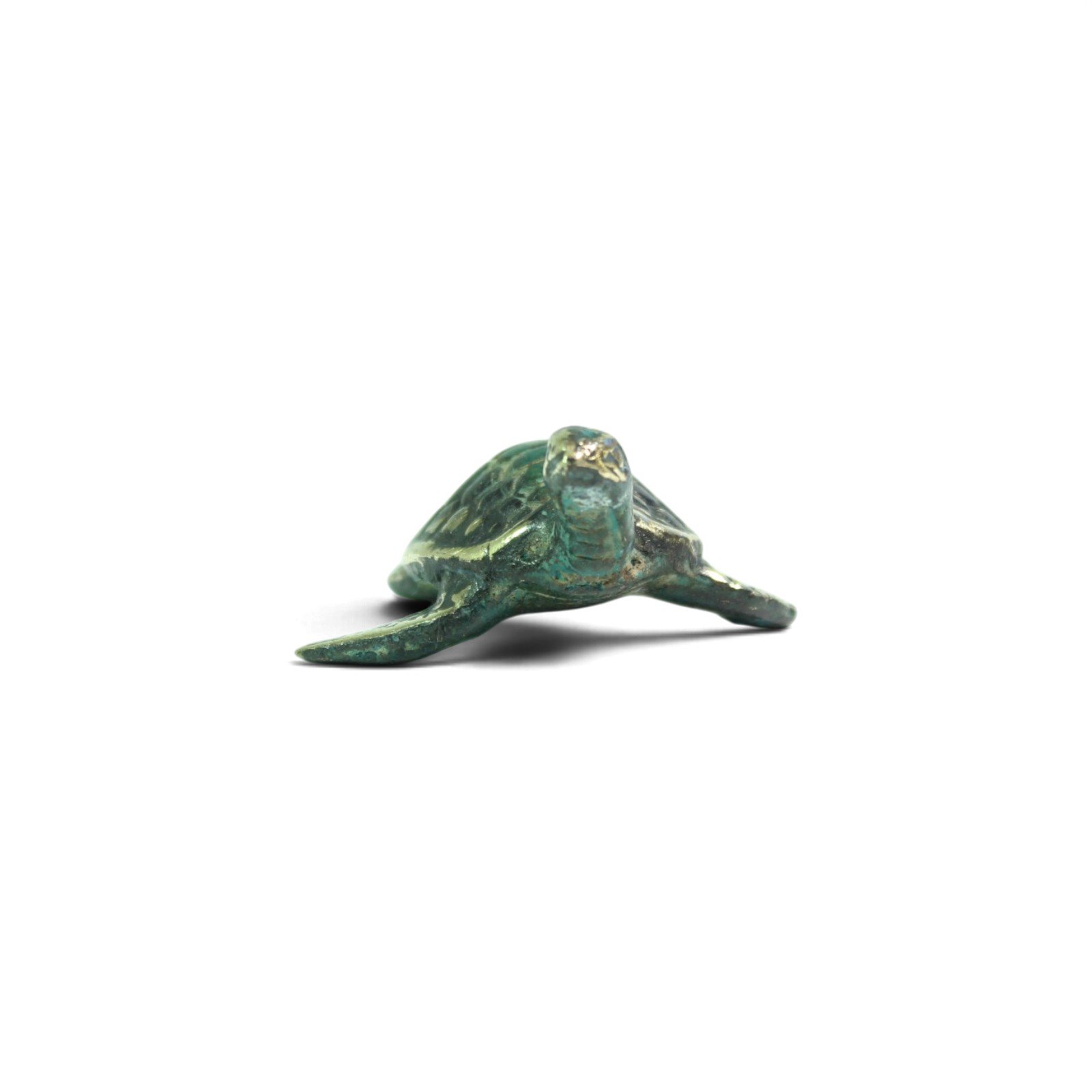 Front view of hand-cast brass turtle figurine with head raised