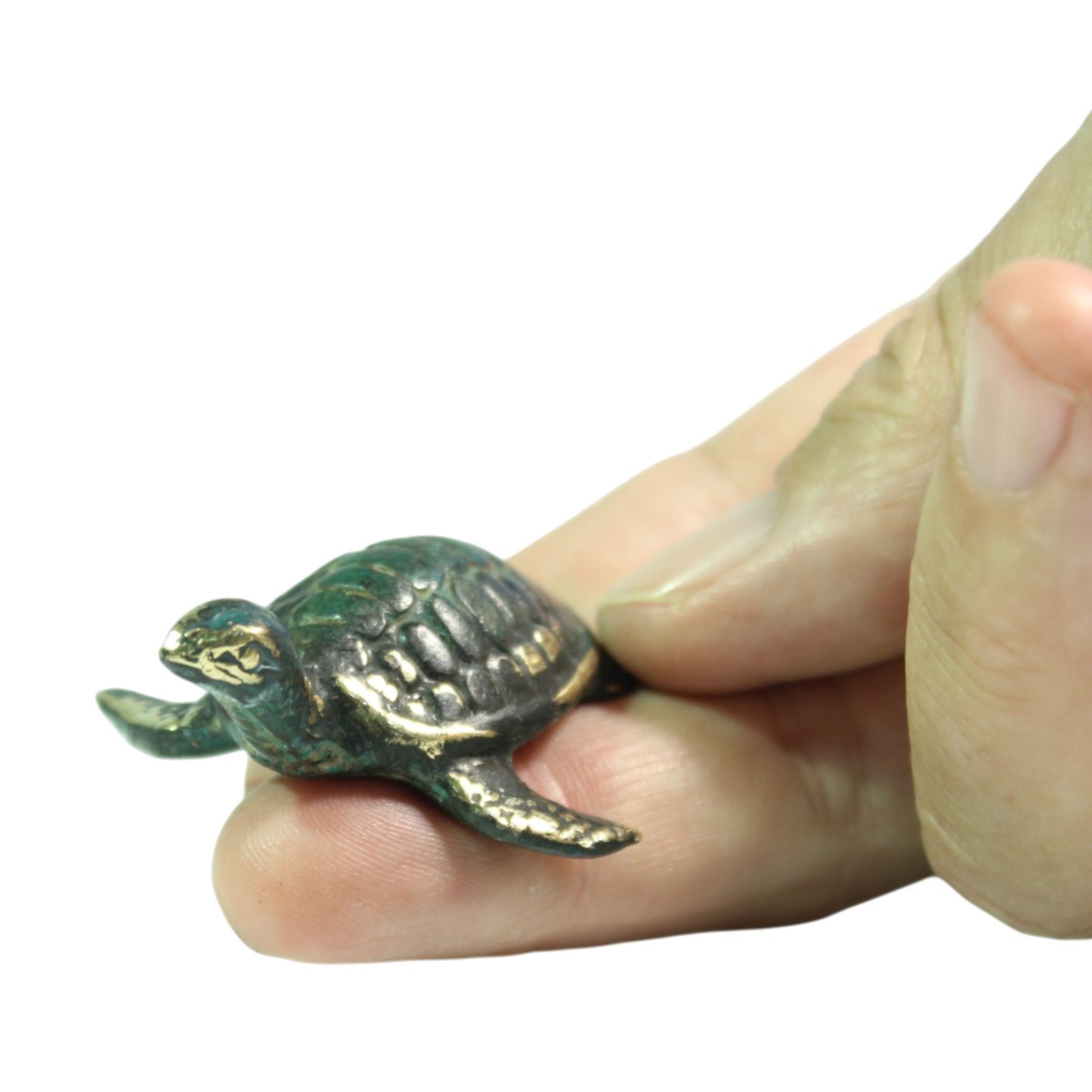 Brass turtle figurine held between two fingers to show its small scale