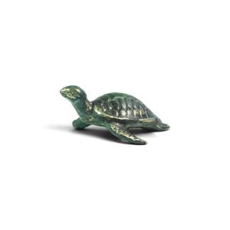 Brass sea turtle figurine with teal-green oxidized patina, side view on white background