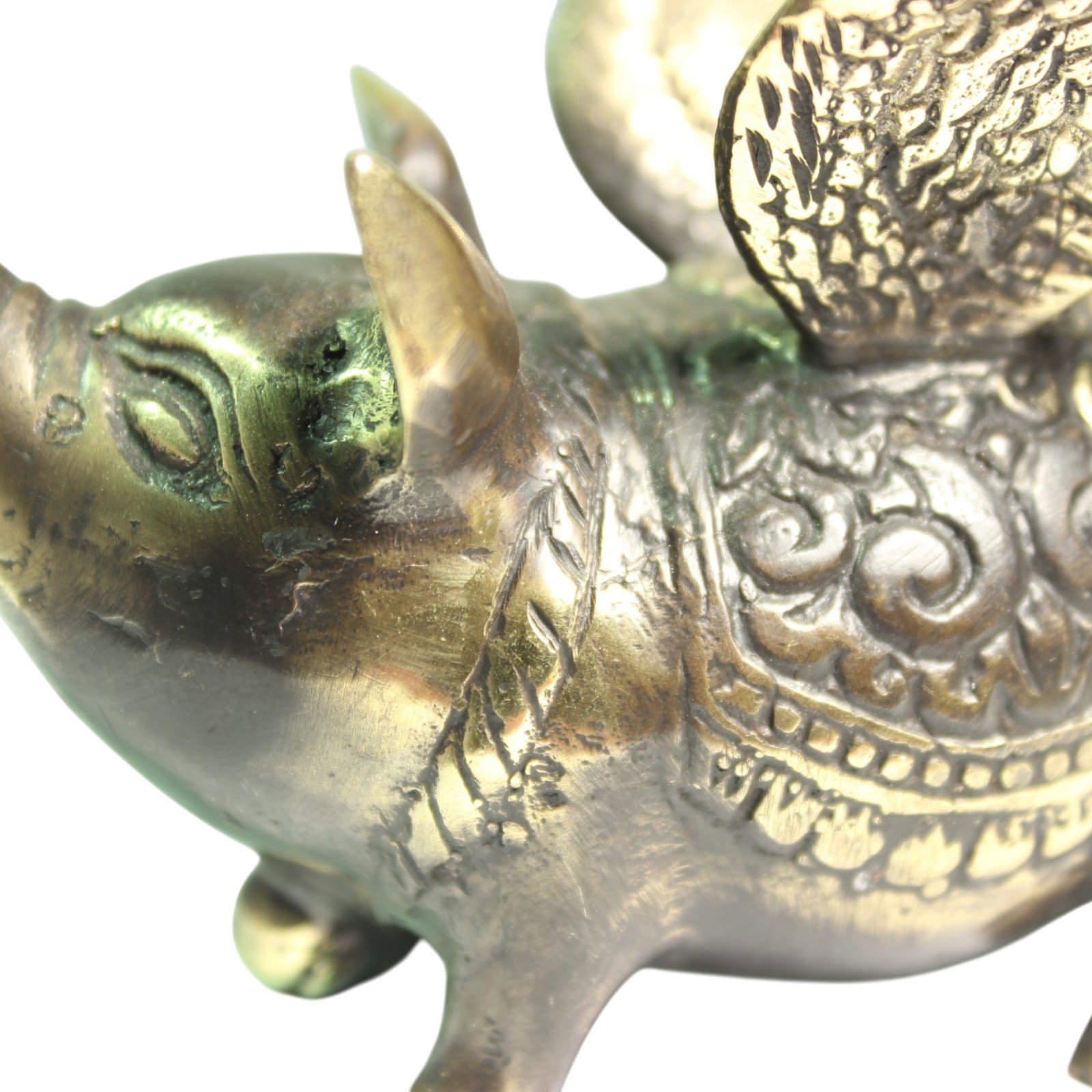 Close side View of hand-cast brass pig showing carved wing feathers and back pattern