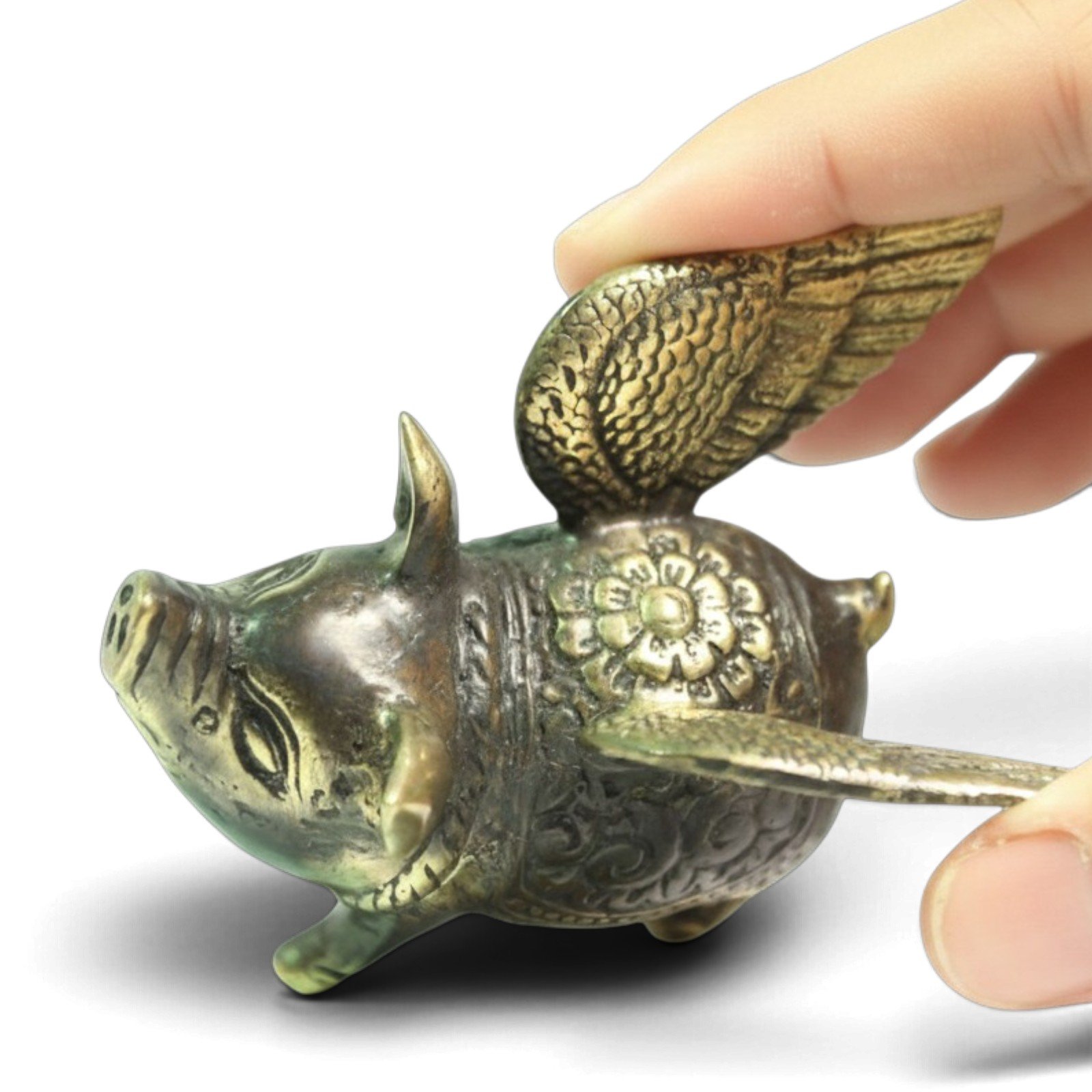 Top View of hand-cast brass pig showing carved wing feathers and back pattern