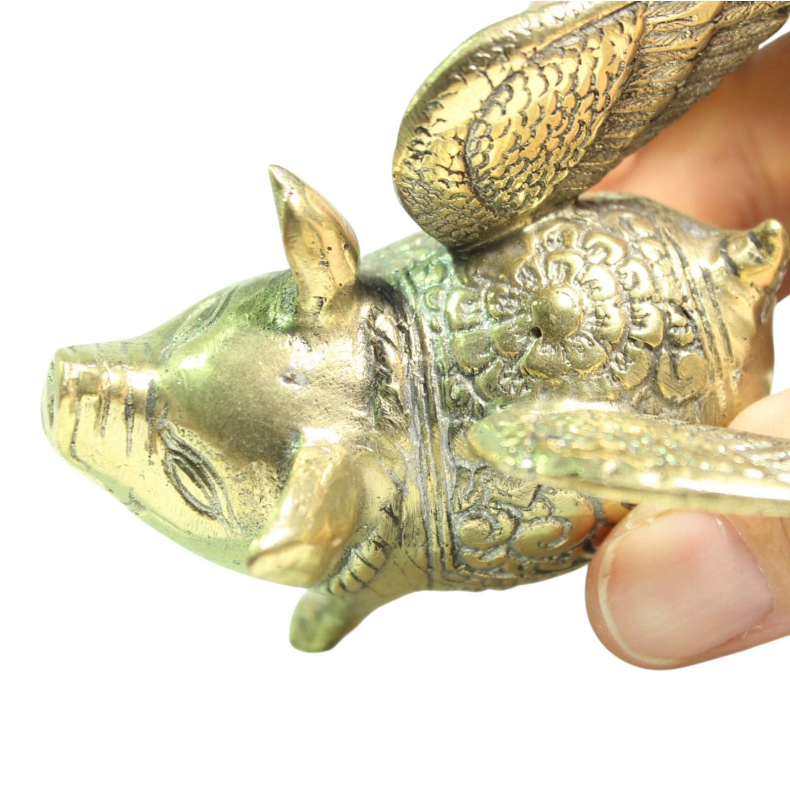 Brass winged pig figurine viewed from the top, showing detailed feathered wings and engraved saddle pattern