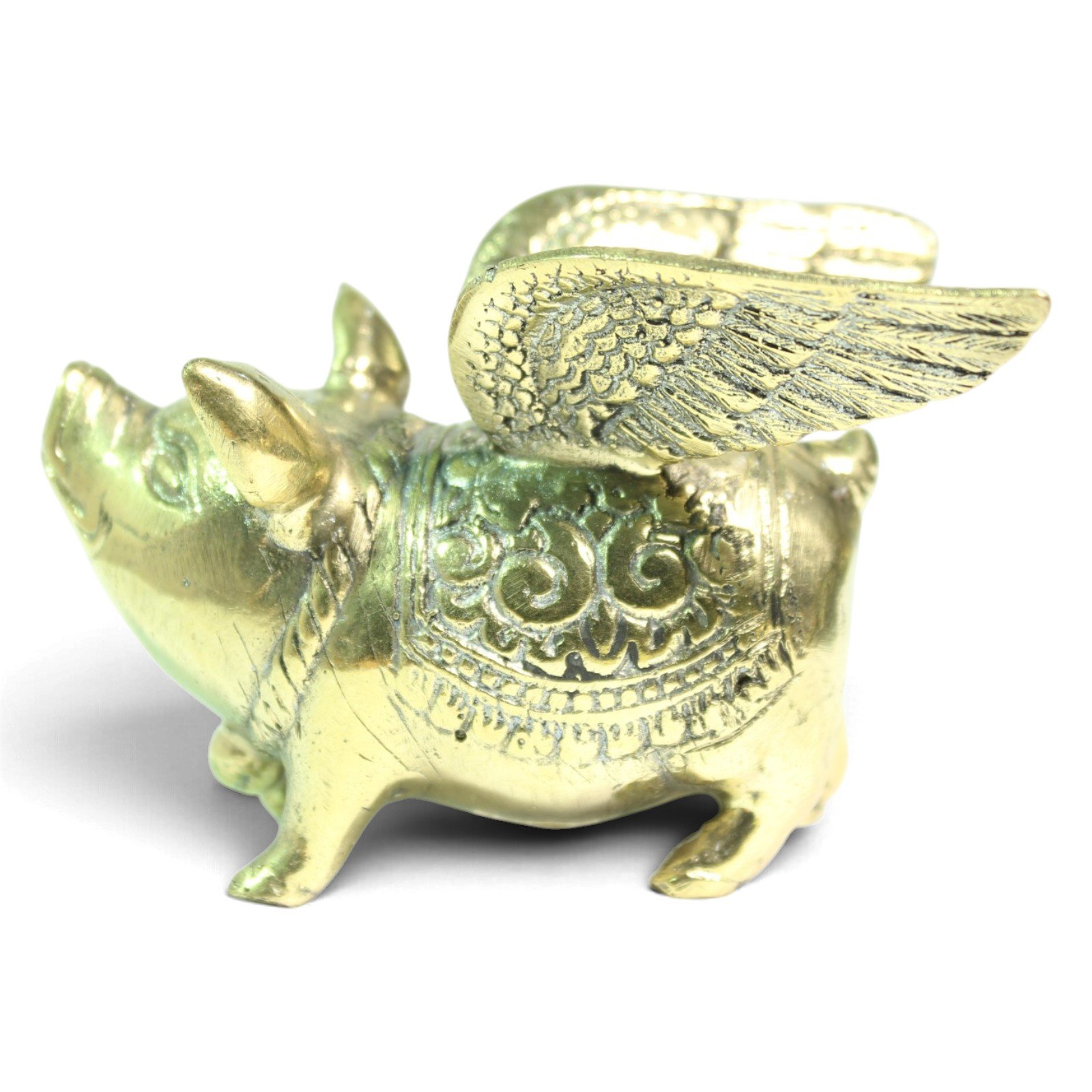 Rear angle view of brass winged pig showing wing structure and engraved back pattern