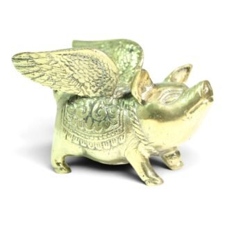 Brass winged pig figurine viewed from the side, showing detailed feathered wings and engraved saddle pattern