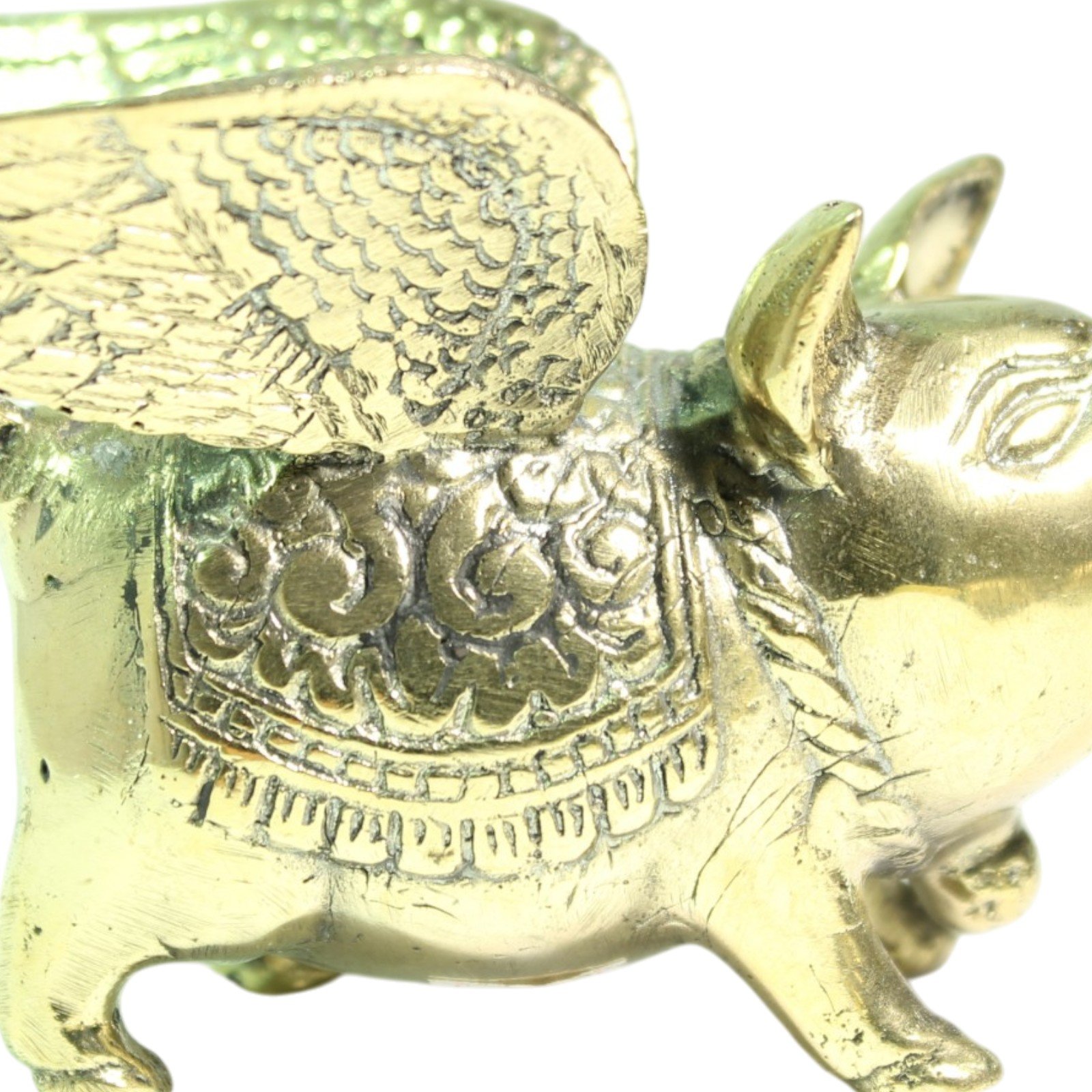 Close-up of brass pig's wing feather etching and scrollwork saddle detail
