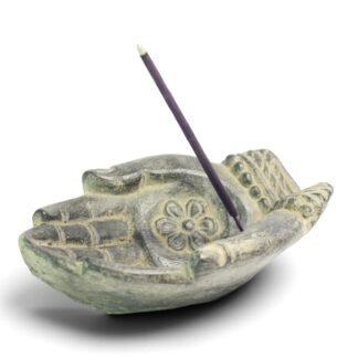 Buddha hand mudra incense holder with lotus carving and lit incense stick, angled view