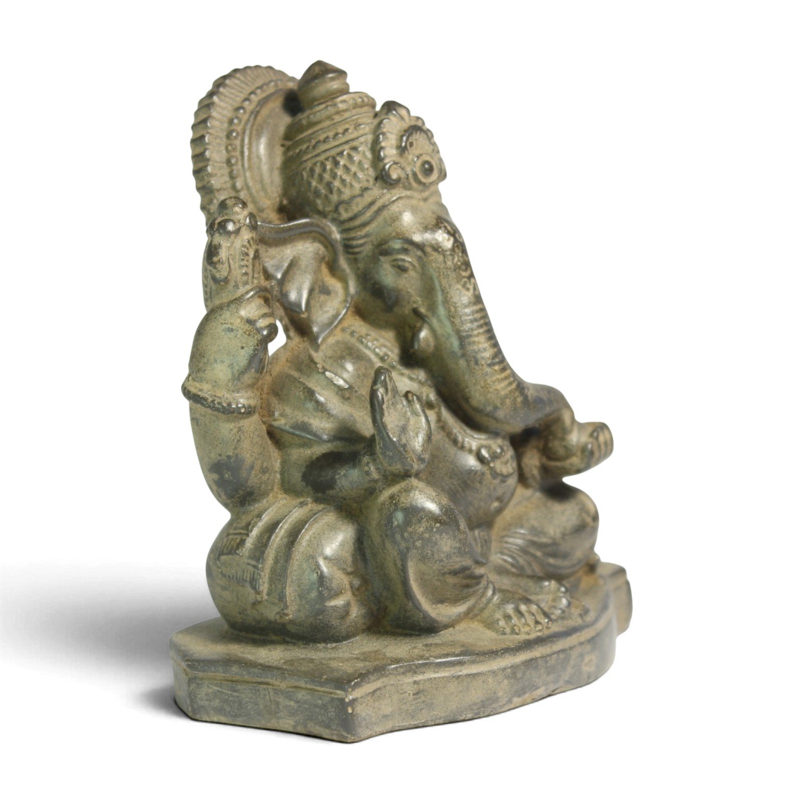 Side angle view of Ganesha statue showing raised arm and lotus base