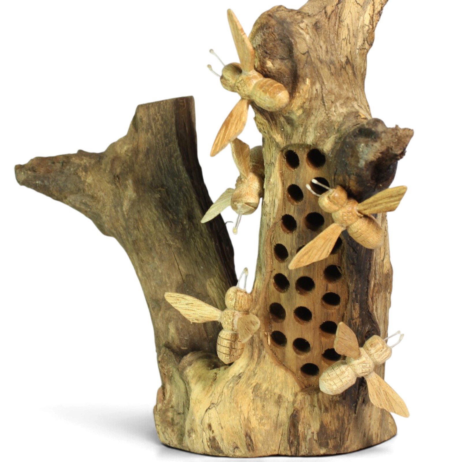 Close angle of carved bees clustered around drilled honeycomb holes in wood