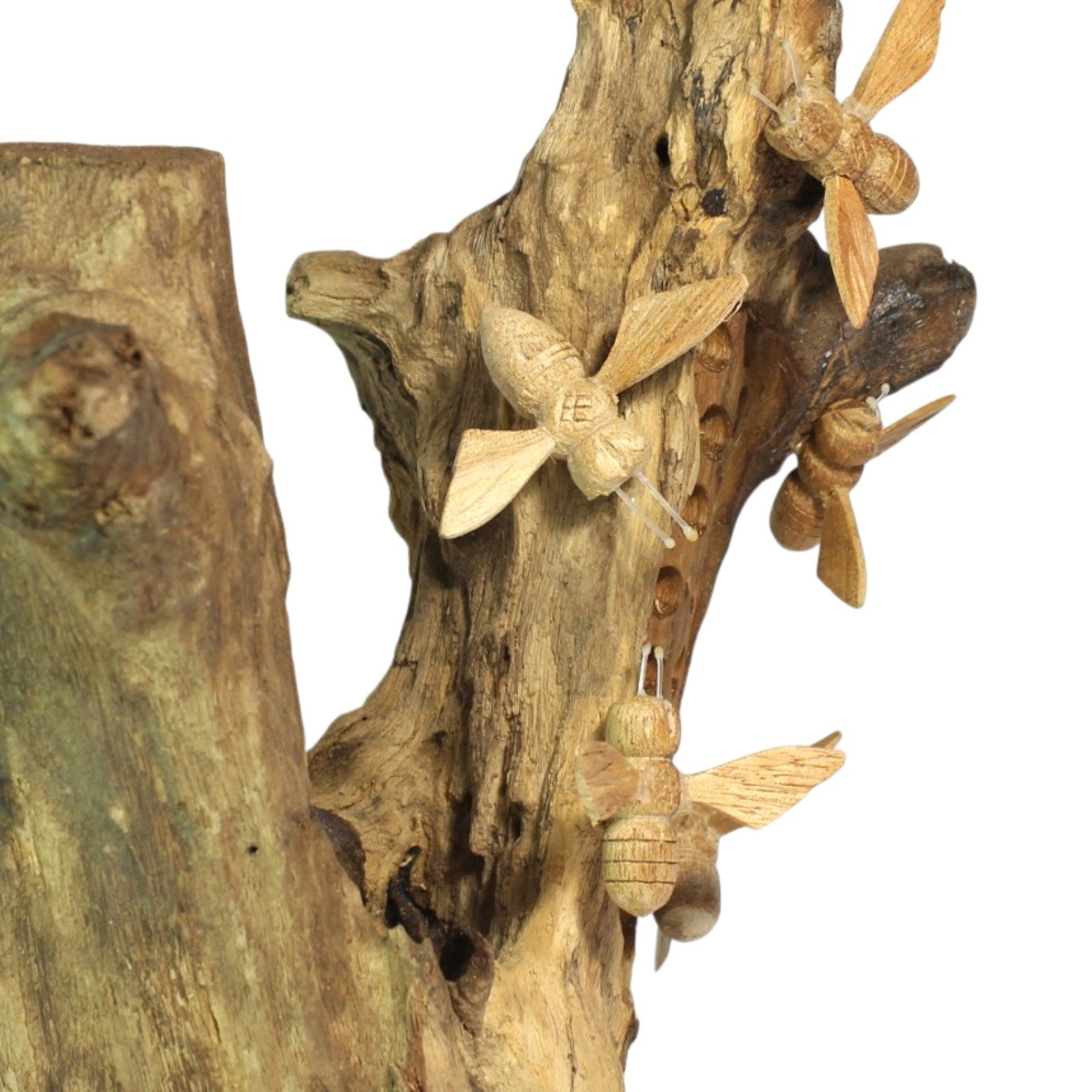 Detail of a carved wooden bee with wire antennae near the hive holes