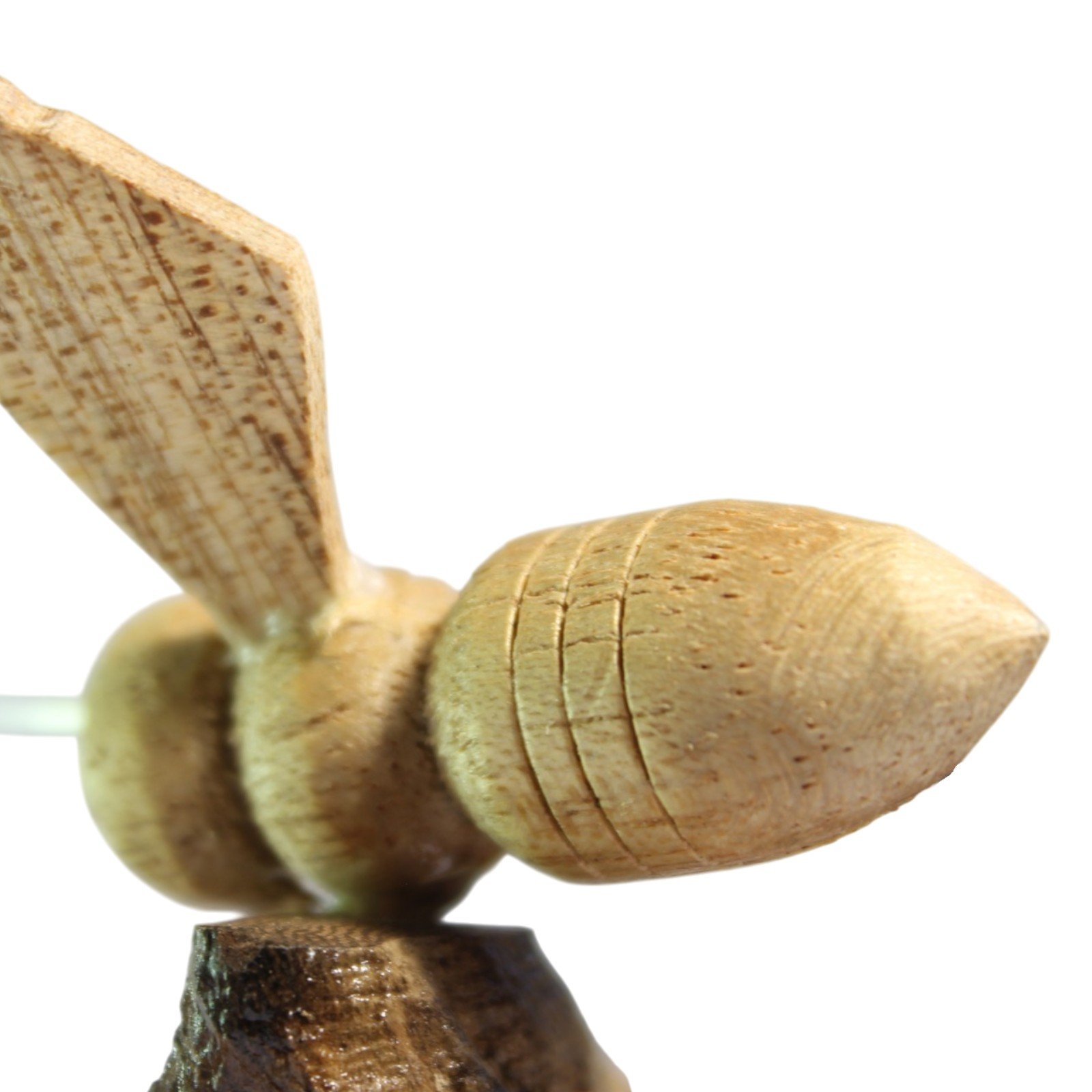 Close-up of a single carved bee showing wing grain and ridged abdomen