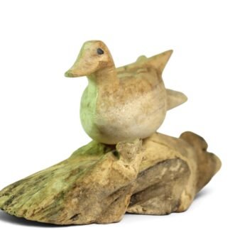 Hand-carved wooden duck painted green and cream, perched on a knotted parasite wood base