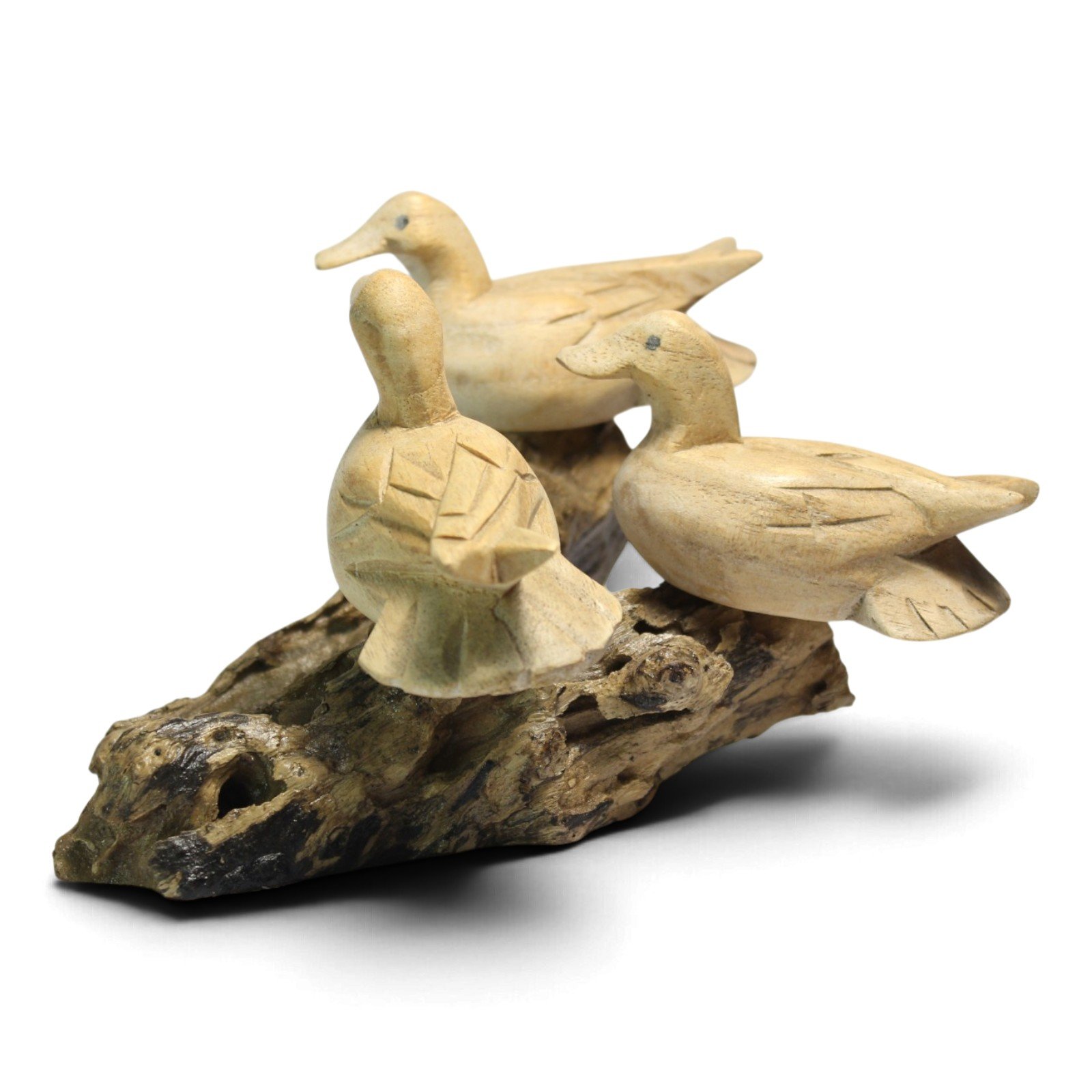 Front-facing view of the three ducks showing varied poses and carved feather detail