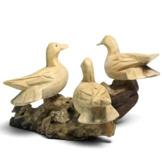Three hand-carved wooden ducks perched together on a gnarled parasite wood base