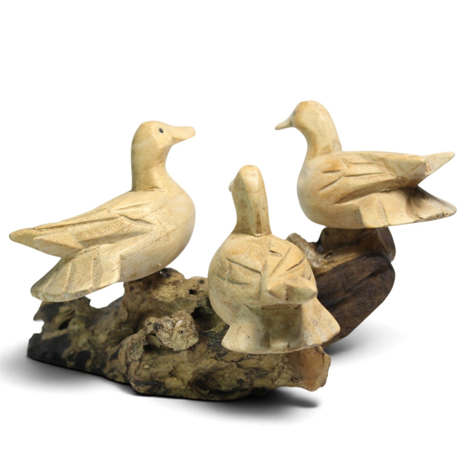 Three hand-carved wooden ducks perched together on a gnarled parasite wood base