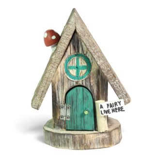 Hand-carved wooden fairy house with green door, round window, and mushroom detail on roof