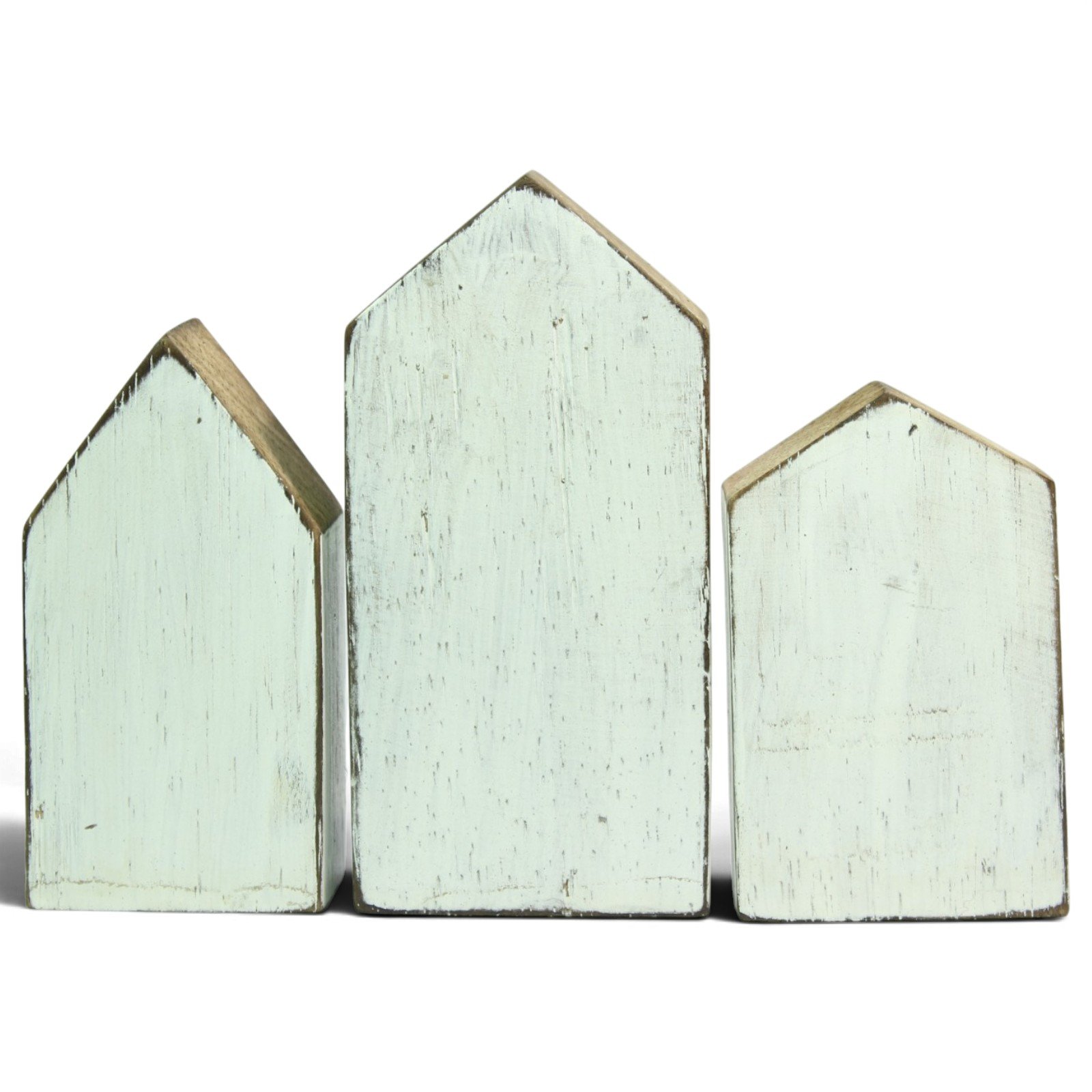 Back view of three wooden houses showing plain whitewashed panels and distressed paint finish