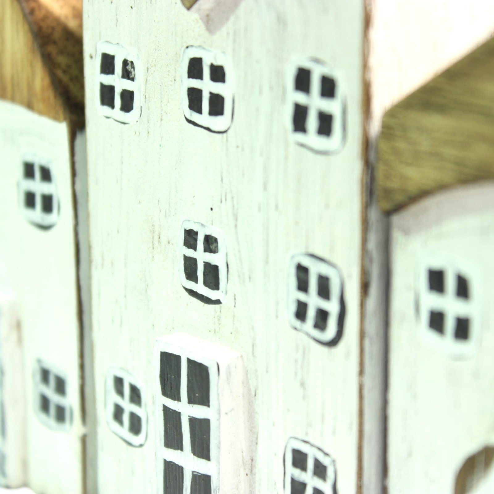 Close-up angle showing rows of hand-painted windows across multiple house facades