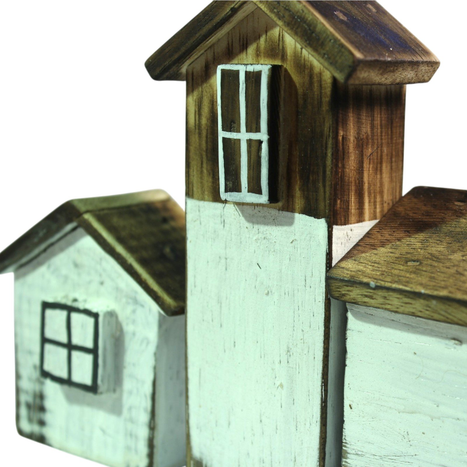 Close-up of a tall wooden house roof peak next to a smaller house's sloped roof