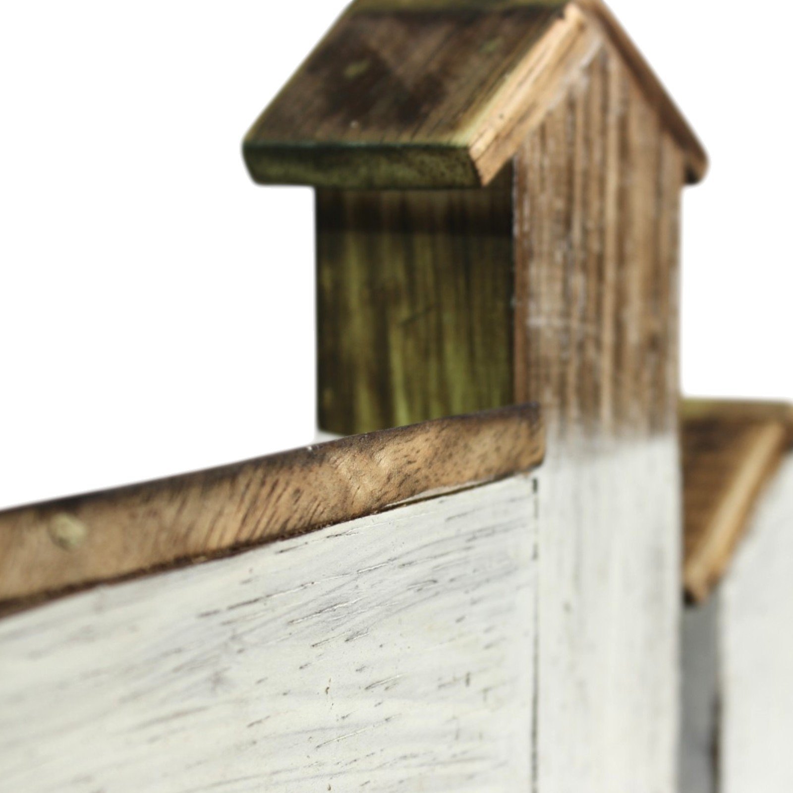 Close-up of two wooden house rooftops with a small chimney-like tower in soft focus