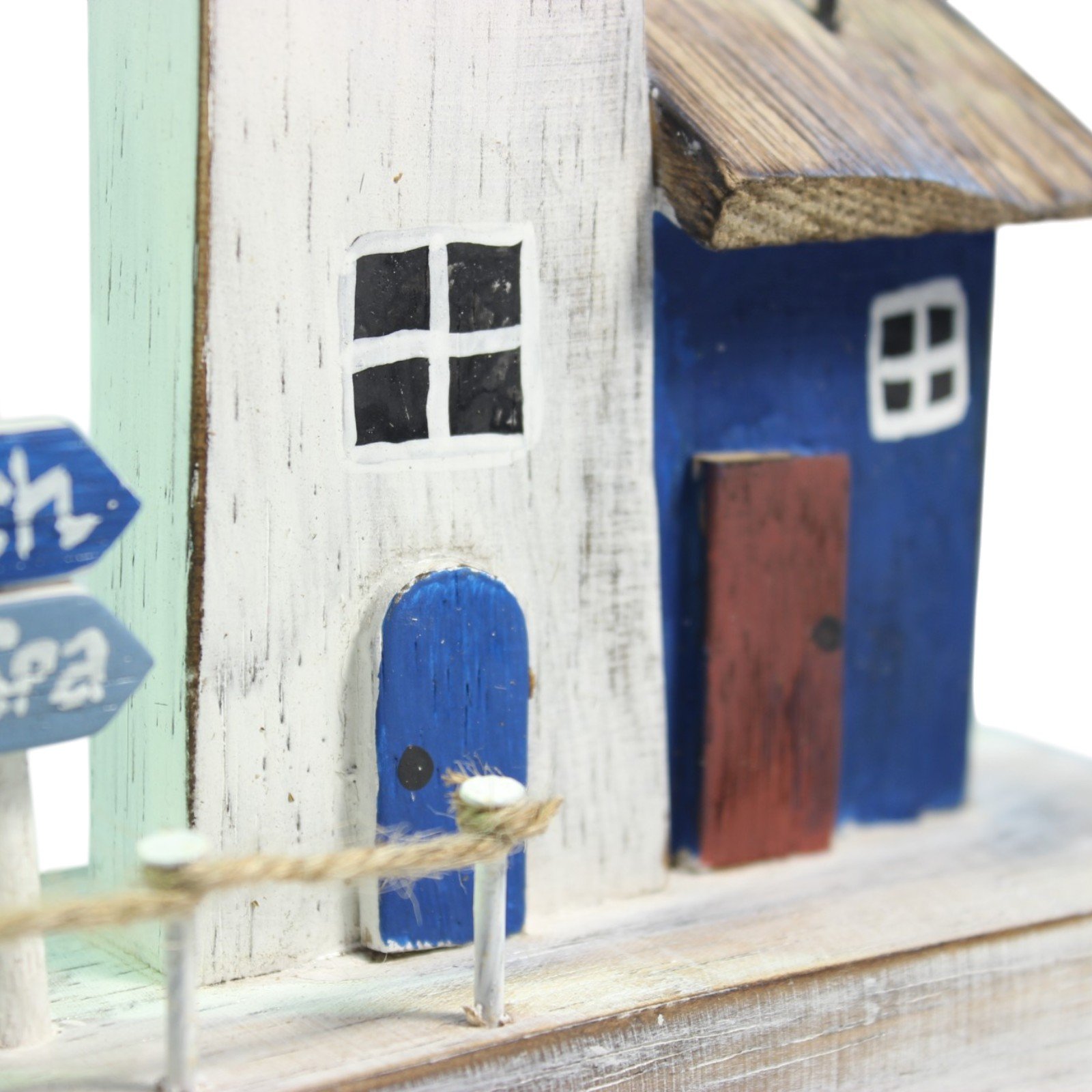 Close-up of the cottage windows and doors with visible brush texture