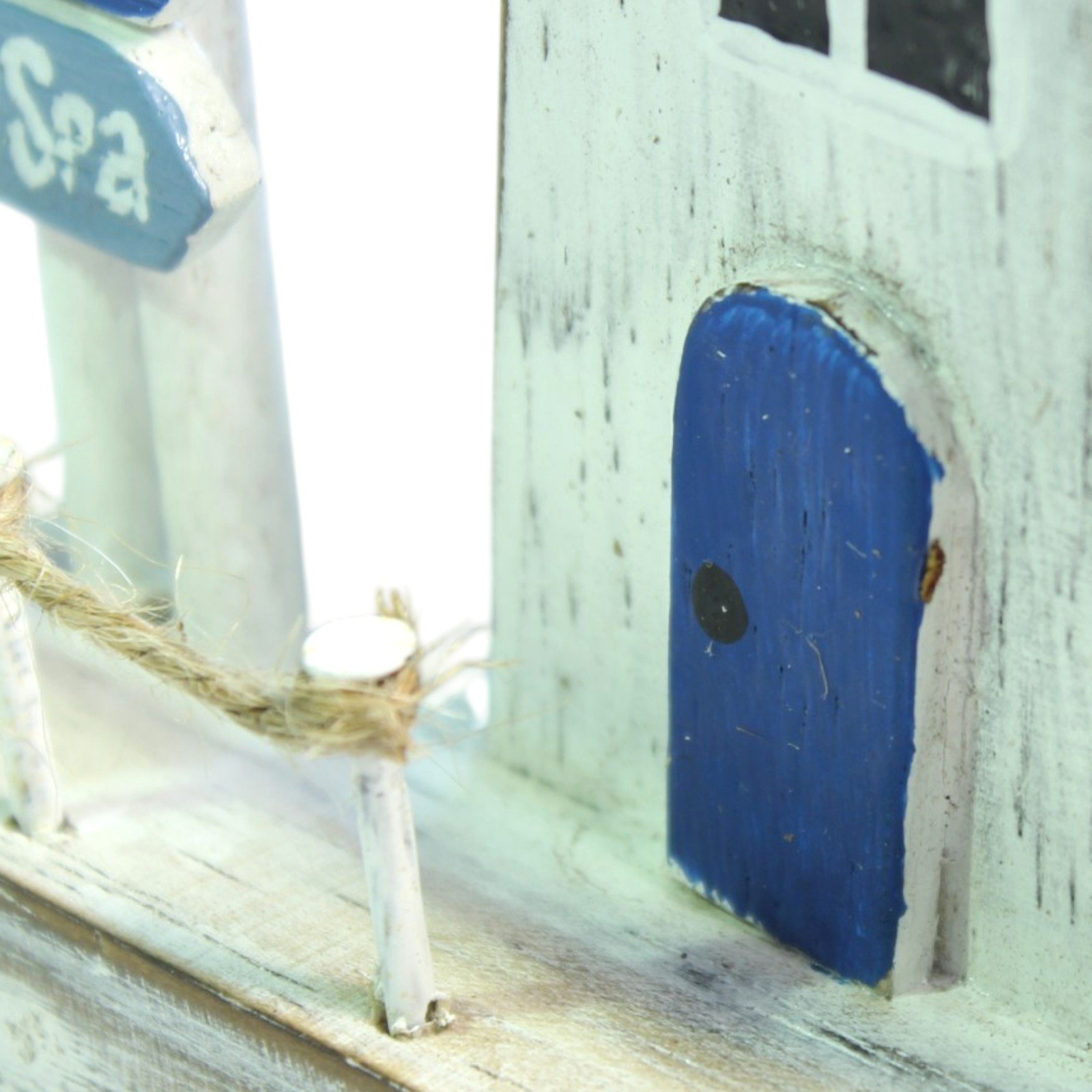 Close-up of the lighthouse's blue door with visible paint texture and grain