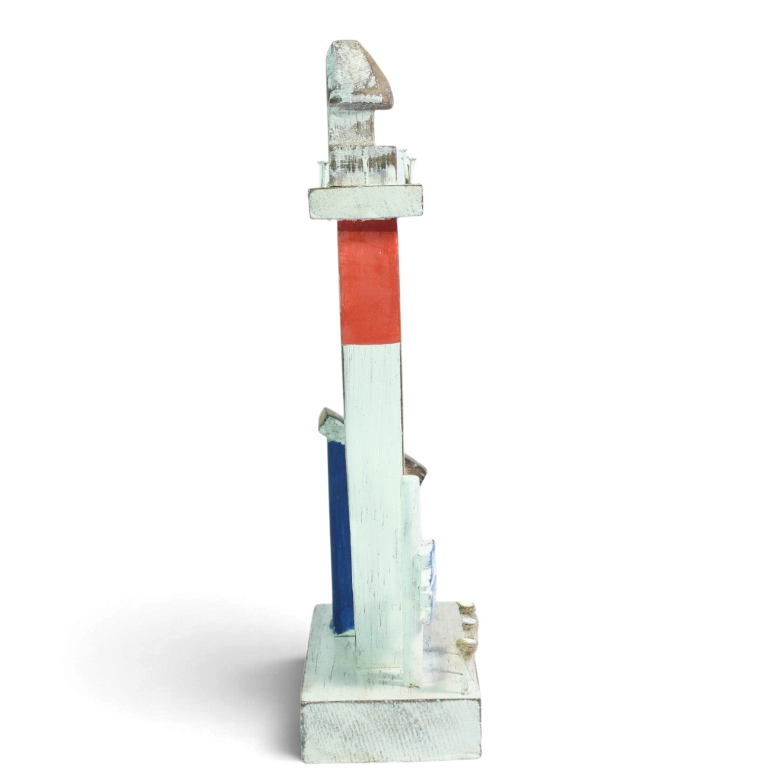 Side profile of the lighthouse showing its red and white painted stripes