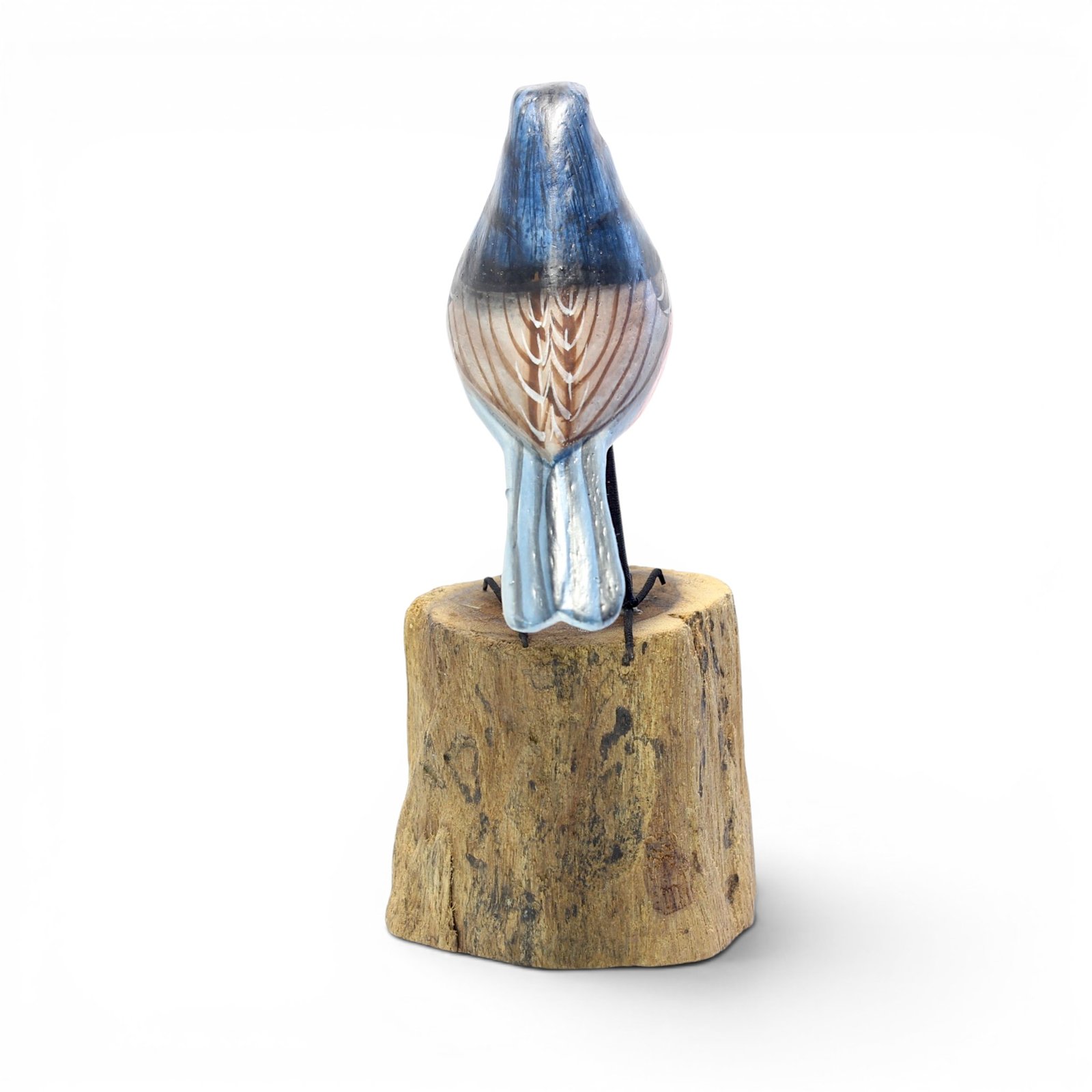 Back view of hand-carved wooden robin figurine showing pale blue tail and wing detail