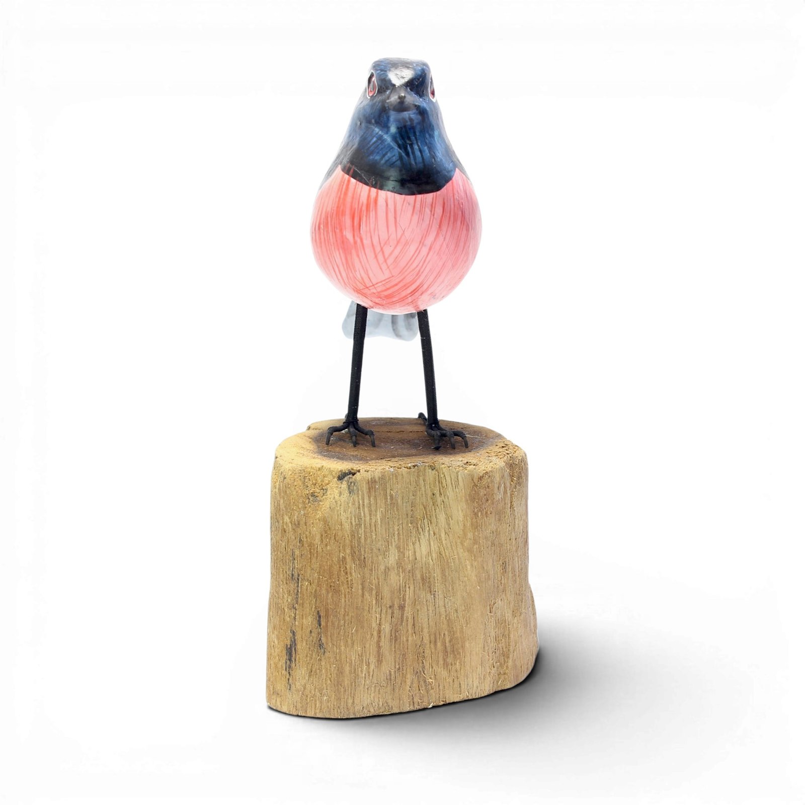 Hand-carved wooden robin bird figurine from Bali with pink chest and blue head, standing on wood base